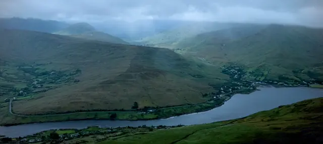 A lake cradled between hillsides in the Connemara mountains
