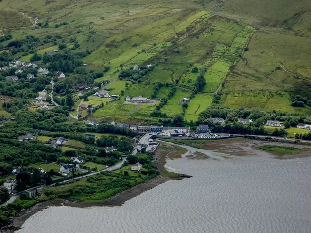 Green fields running down to Leenane village on Killary Harbour
