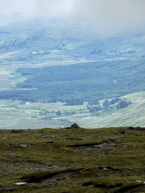 Looking down a hazy valley from high on the ridge