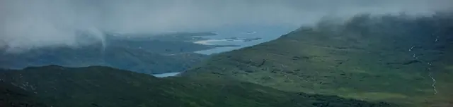 Wide panorama of lakes and low islands in soft mist