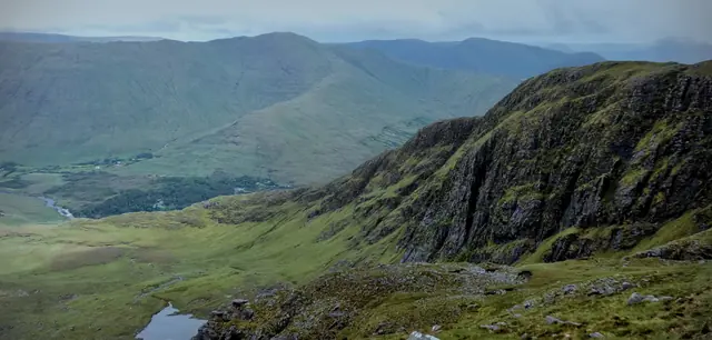 Rocky summit ridge above a green valley
