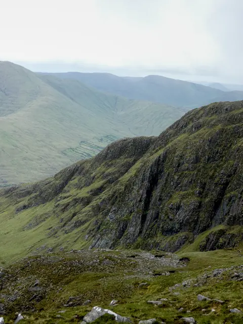 A steep scree slope falling away from the ridge