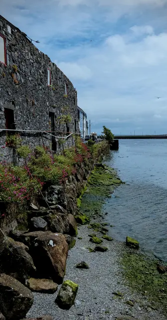 An old stone wall running out into the bay